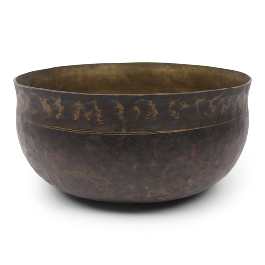Bronze bowl with a textured surface on a white background