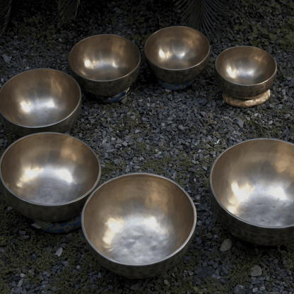 Set of metallic bowls on a gravel surface