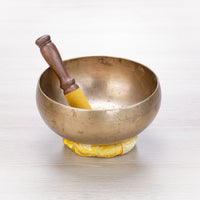 Antique Peter Hase singing bowl with yellow leather mallet, ready for sound healing and meditation