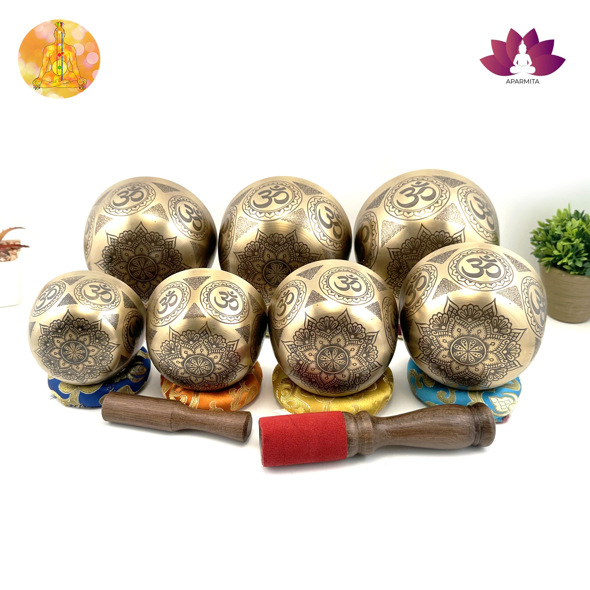 Set of bronze singing bowls with OM symbols on a white background
