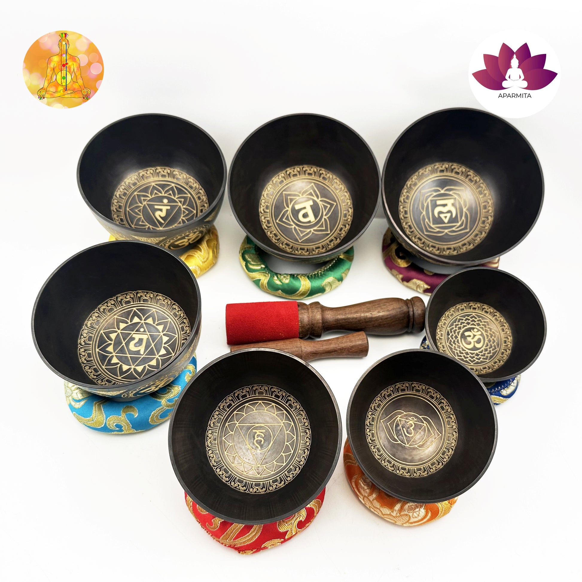 Set of black singing bowls with gold designs on a white background, featuring Ananta brand logo.