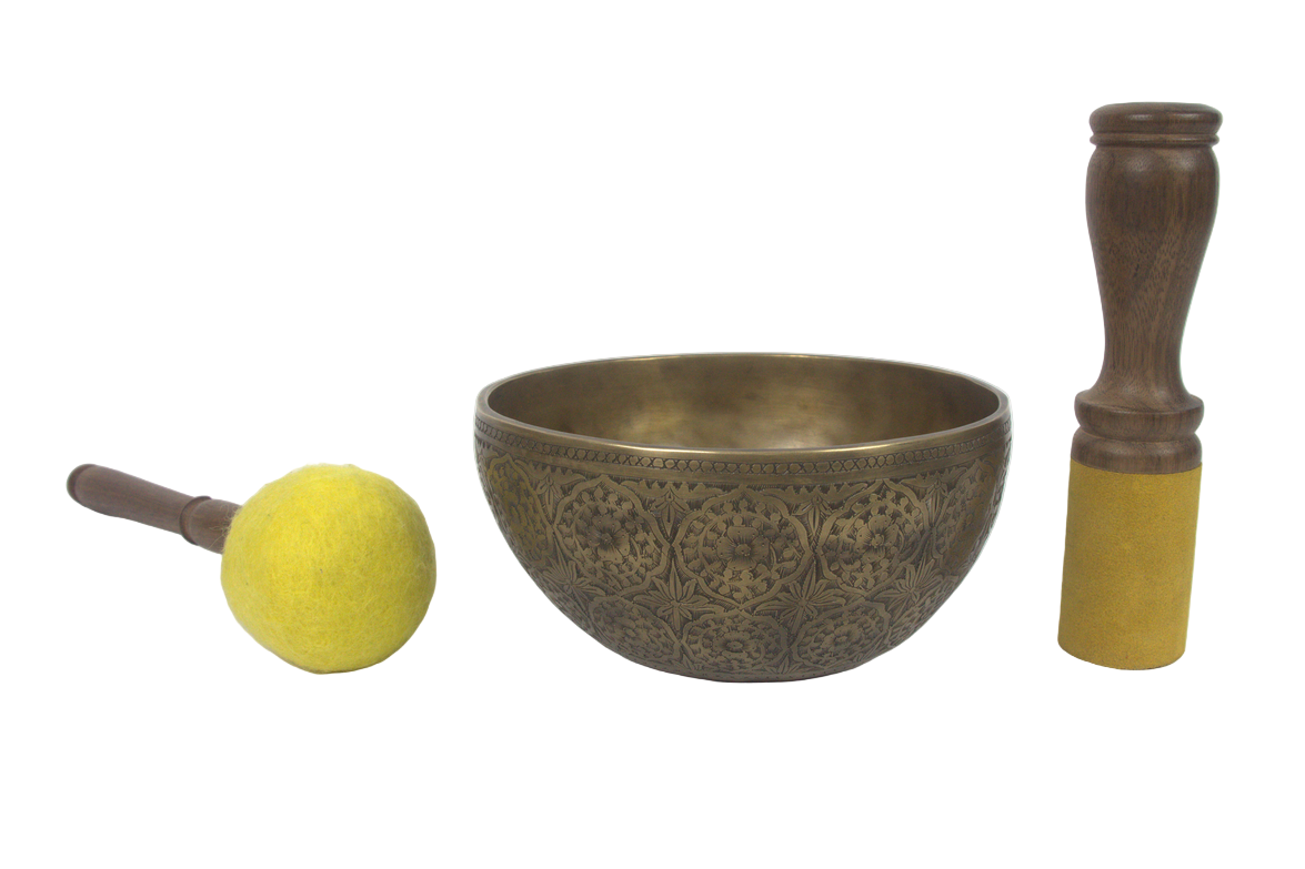 Decorative bronze singing bowl with a mallet and beater on a white background
