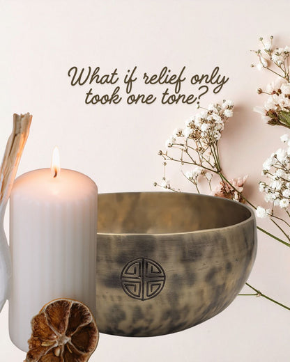 Tibetan singing bowl with a candle and flowers on a light background