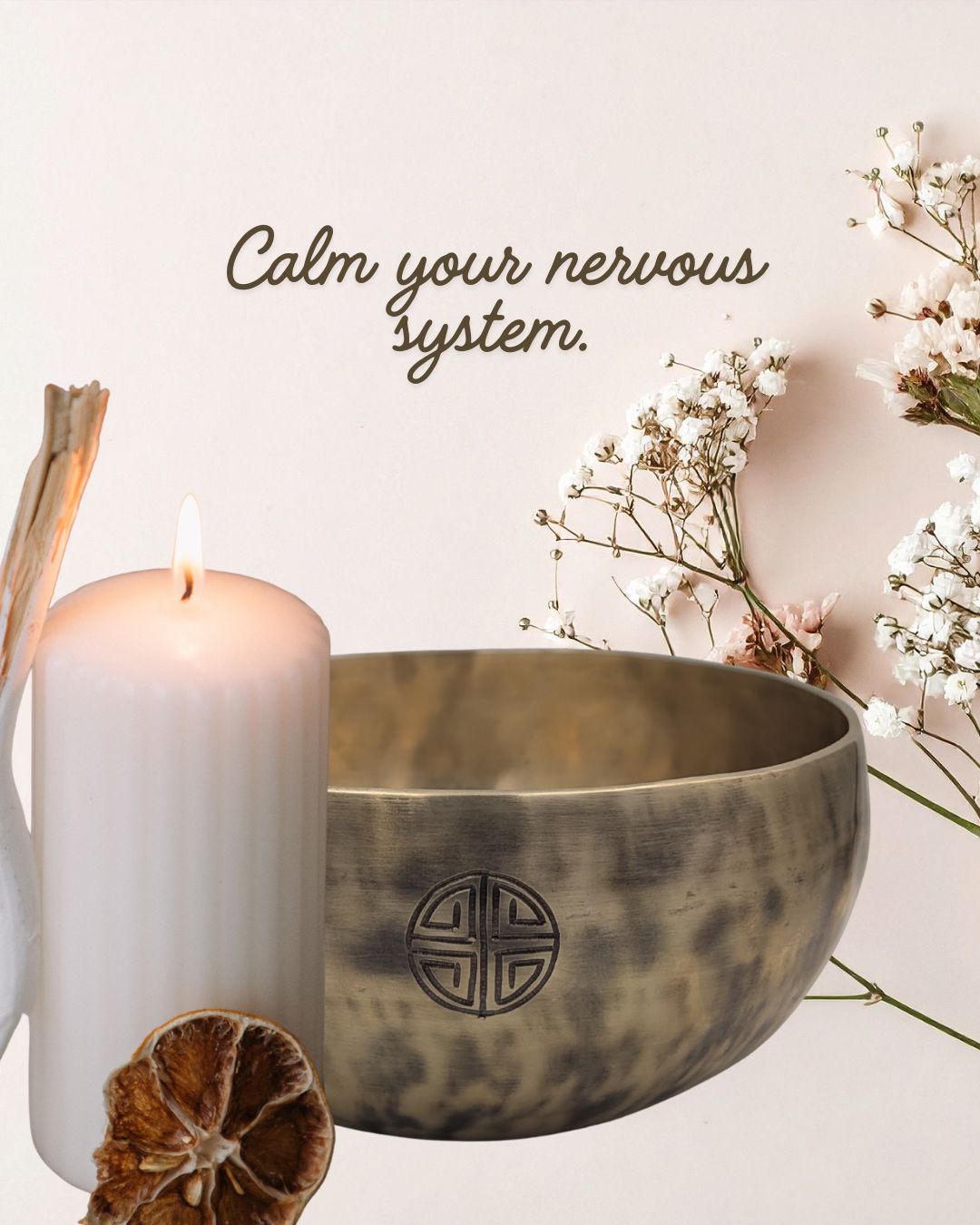 Tibetan singing bowl with candle and flowers on a light background