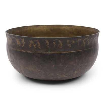 Bronze bowl with a textured surface on a white background
