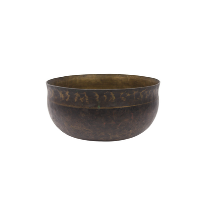 Bronze bowl with textured surface on a white background