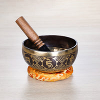 Laser carved singing bowl with Om Mani Padme Hum Tibetan script medallions and gold geometric etching on dark bronze finish — handcrafted in Nepal