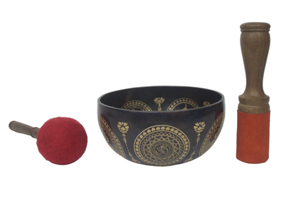 Decorative singing bowl with a mallet on a white background