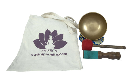 Tibetan singing bowl set with a white tote bag featuring Aparmita branding on a white background.