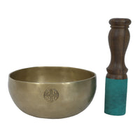 Bronze singing bowl with wooden handle on a white background