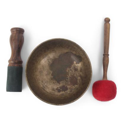 Bronze singing bowl with wooden mallets on a white background